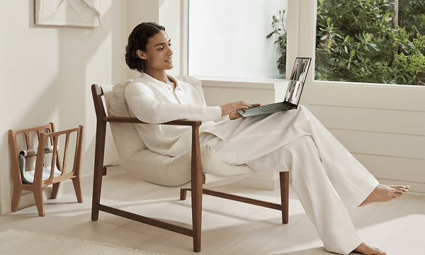 Person sidder i en stol med ASUS Zenbook S 16 laptop