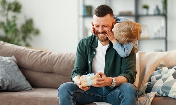 Man receiving a present from his son on Father's Day