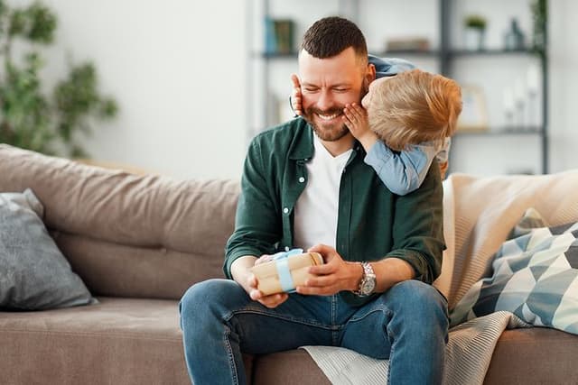 Man receiving a present from his son on Father's Day