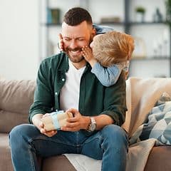 Man receiving a present from his son on Father's Day