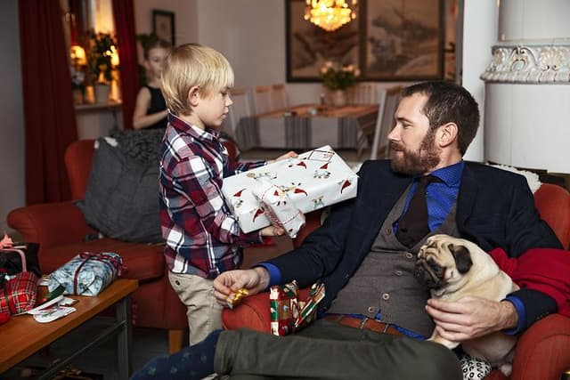 Dad getting christmas gift from his son 