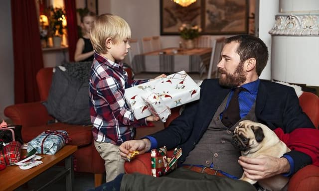 Dad getting christmas gift from his son 