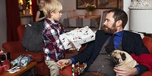 Dad getting christmas gift from his son 