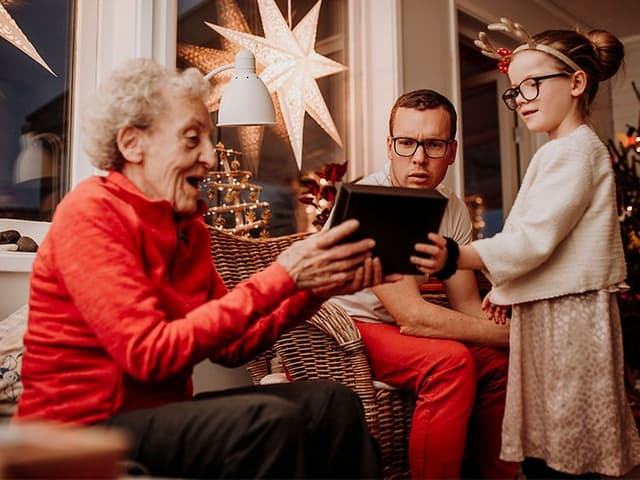 Festive scene with wrapped presents, holiday decor, and cozy lighting, suggesting thoughtful Christmas gifts for grandparents.