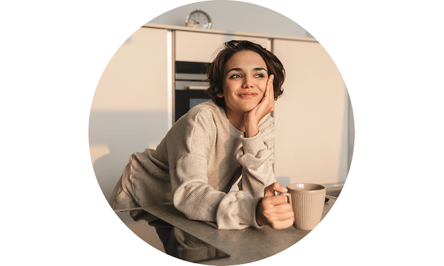 Woman holding cup in kitchen