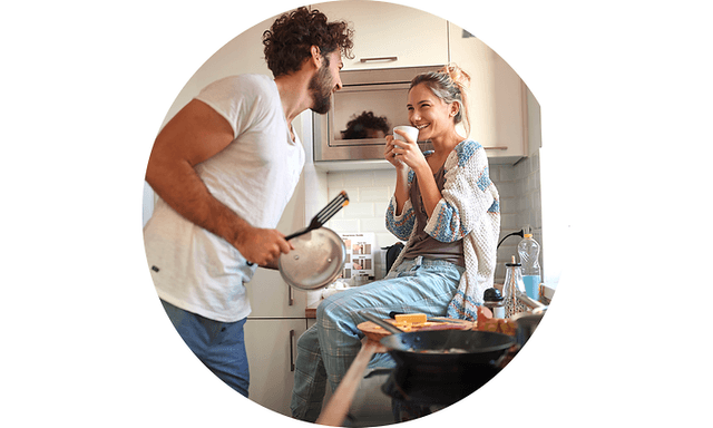 Couple smiling in kitchen