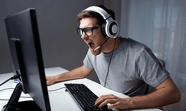 mann med gaming-headset skriker til pc-skjermen