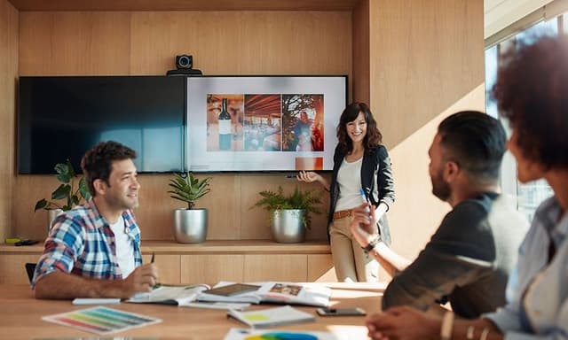 B2B - CS - Woman holding a presentation where contents is shown on meeting room TV