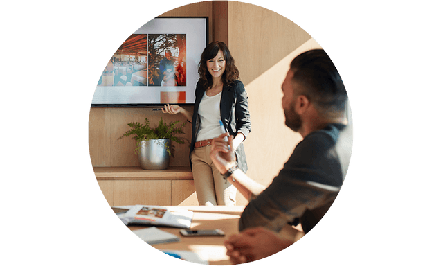 Woman holding a presentation where contents is shown on meeting room TV