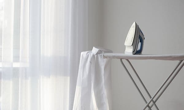 White shirt and an iron on an ironing board