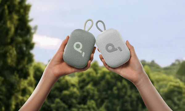 Hands holding two Select 4 Go speakers
