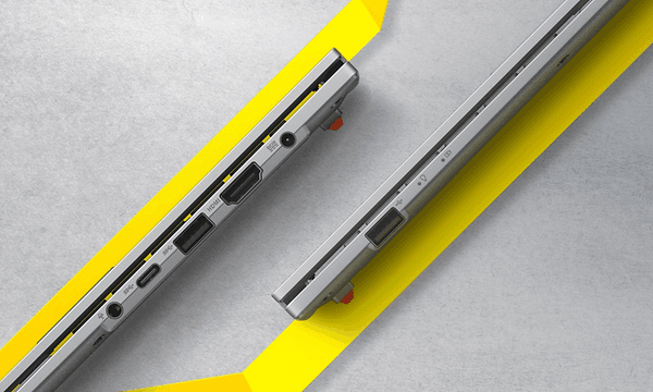 Thin ASUS Vivobook Go 15 laptops on a grey background with yellow stripes 