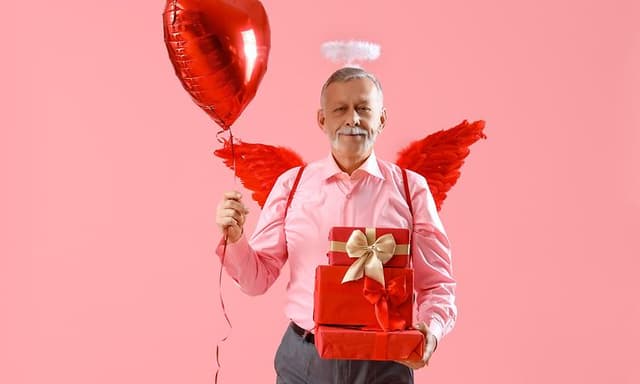 Old man celebrating valentine's day with cute outfit and heart balloon