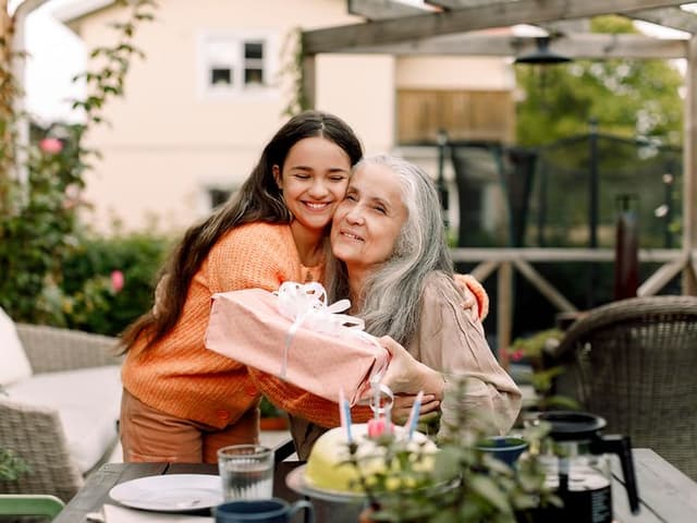 Younger woman hugging older one