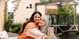 Younger woman hugging older one