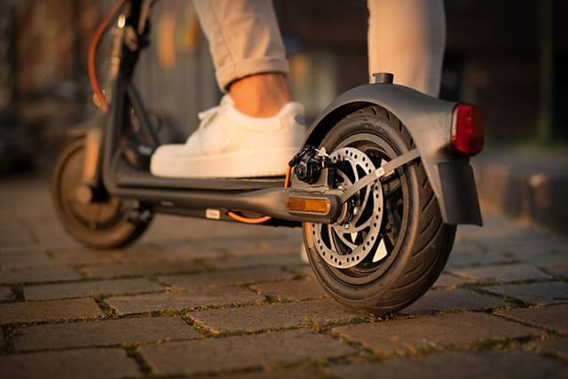 Close up of the test winner Ninebot Segway Electric Scooter being used by a man 