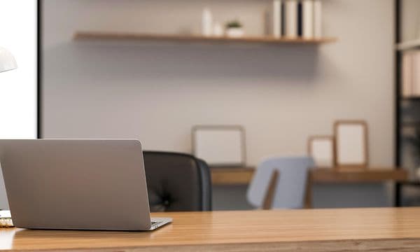 Laptop on a wooden desk in modern work space