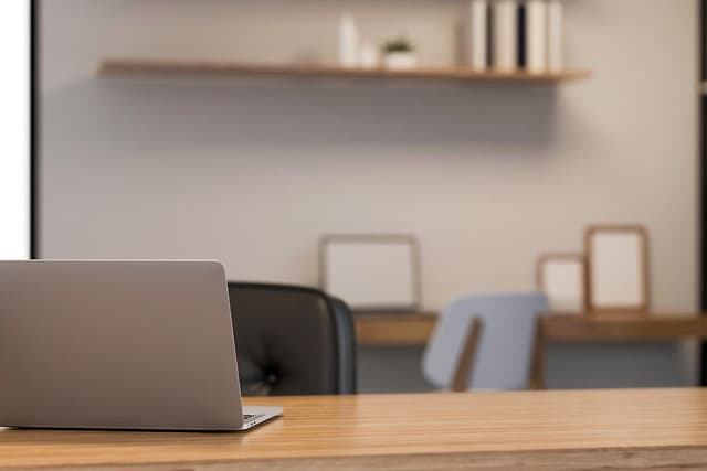 Laptop on a wooden desk in modern work space