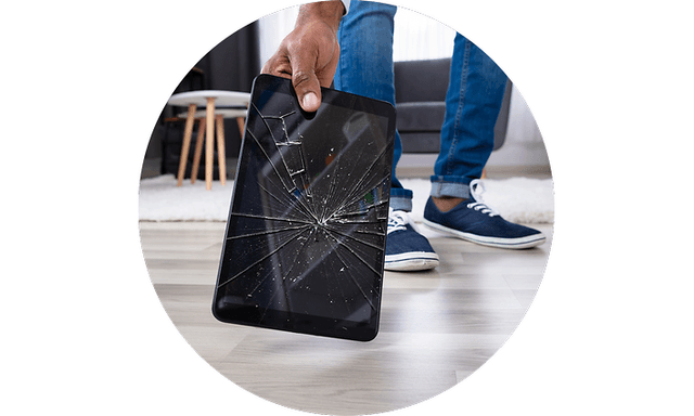 Man picking up broken tablet