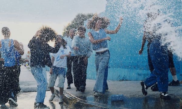 Bose Soundlink Plus on floor in middle of people splashing water