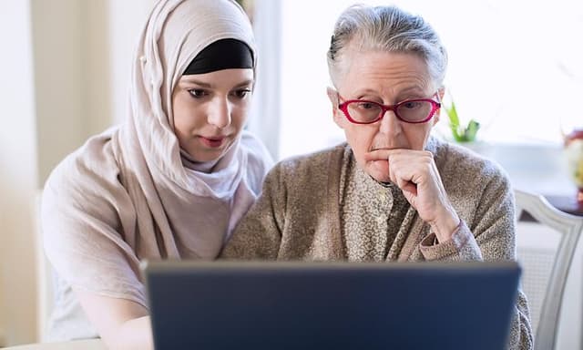 Computing - AI PC - Younger woman helping an older woman using laptop