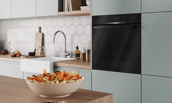 Kitchen with integrated Bosch combination oven and a bowl of vegetables on a table