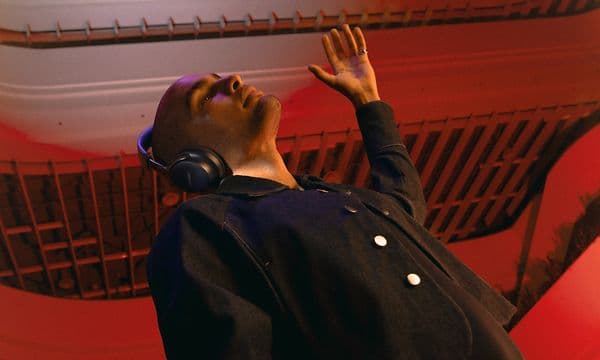 Man with Bose headphones looking up