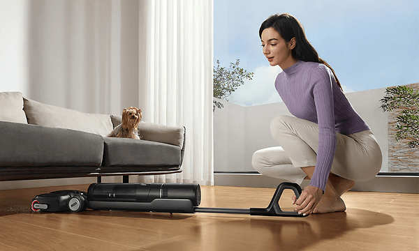 Dreame H12 Pro vacuuming horizontally under the couch thanks to Lie-Flat design
