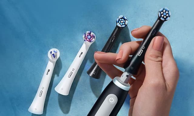 Person holding the Oral-B iO3 electric toothbrush