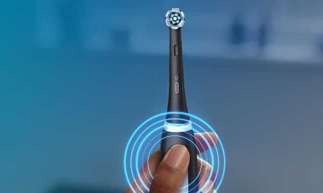 Person holding the Oral-B iO3 electric toothbrush