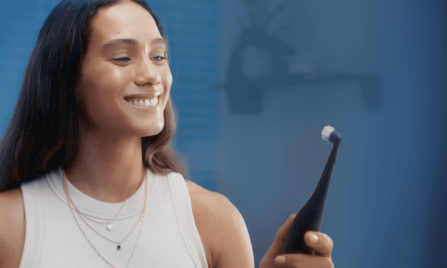 Woman holding toothbrush
