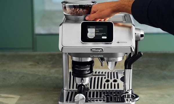 Person adjusting the coffee bean grinder