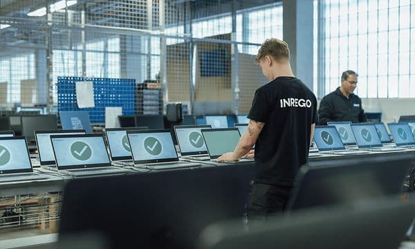 Inrego employees working on several computers that are traded in from a business customer