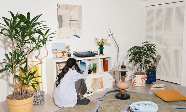 Person listening to vinyls on a Sony LX3BT turntable with a built-in preamp