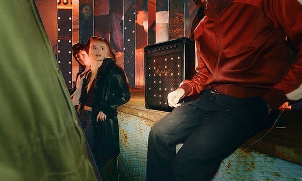 Marshall Bromley 450-høyttaler står på en benk langs en vegg mellom mennesker på fest