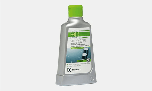 Rengöringsmedel för induktionshäll, vitro care. En grå flaska med gröna detaljer och grön kork.