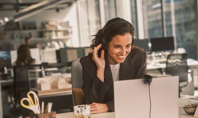 Kvinde arbejder på kontor med Jabra Evolve3 85 høretelefoner