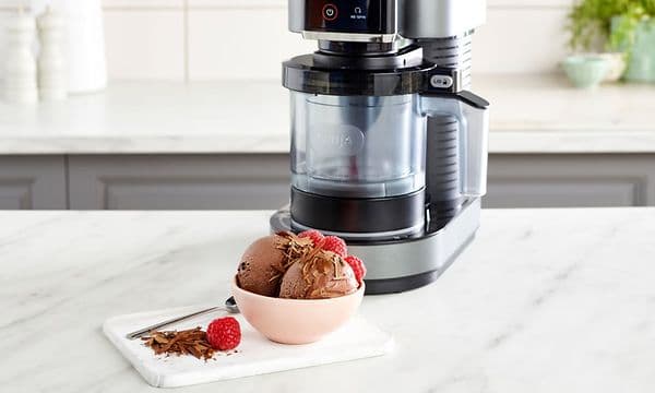 Ninja Creami Ice cream Machine on a Kitchen bench with a bowl with Chocolate Ice Cream
