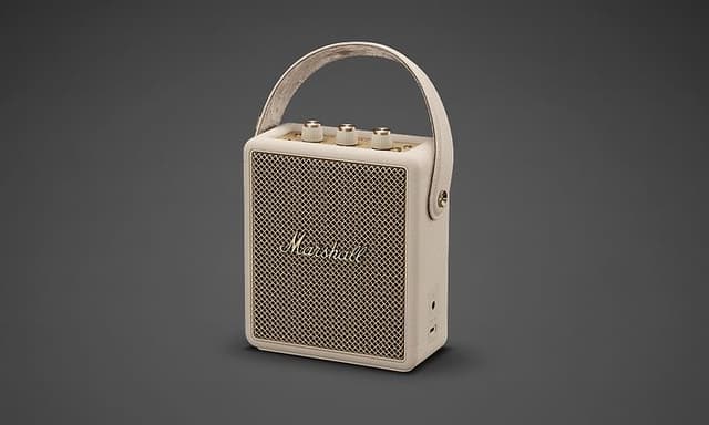 A beige Marshall Stockwell III speaker against a grey background.