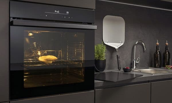 En integrert Hisense pizzaovn i et mørkegrått kjøkken.