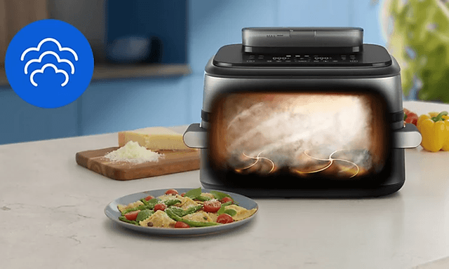 Illustrasjon av mat som dampes i en Philips 5000 airfryer.