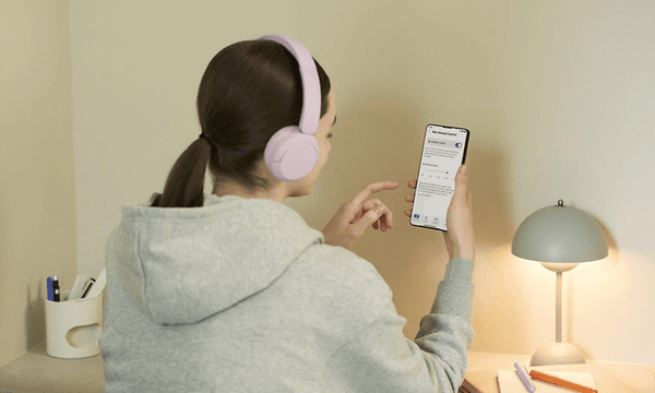 Sony WH-CH530-woman looking at phone