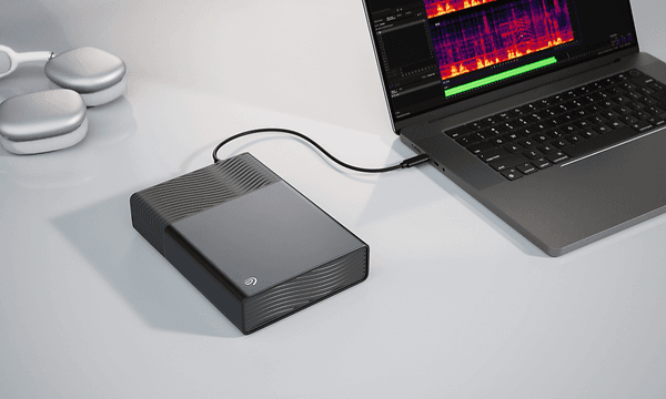 A Seagate OneTouch external hard drive connected to a laptop through a USB-C-cable.