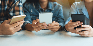 Tre unge der bruger deres smartphones